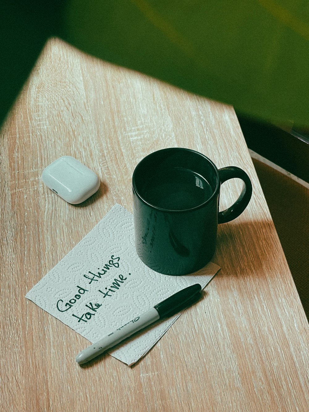 a cup of coffee sitting on top of a wooden table