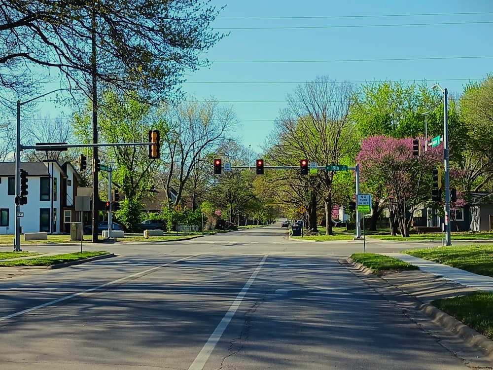 an empty street with a traffic light on a clear day