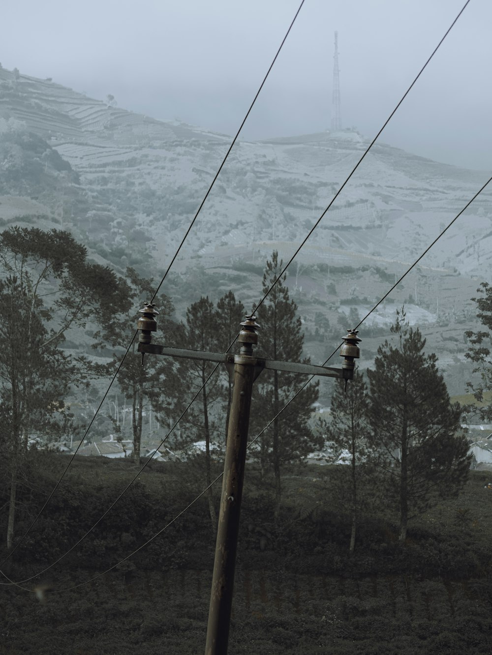 a view of a mountain with power lines in the foreground