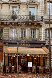 a restaurant with tables and chairs in front of a building