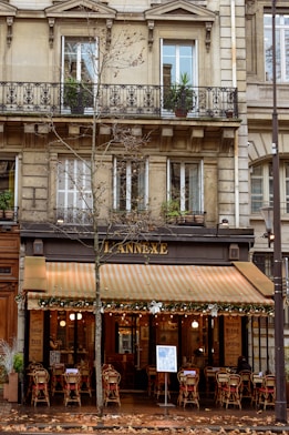 a restaurant with tables and chairs in front of a building