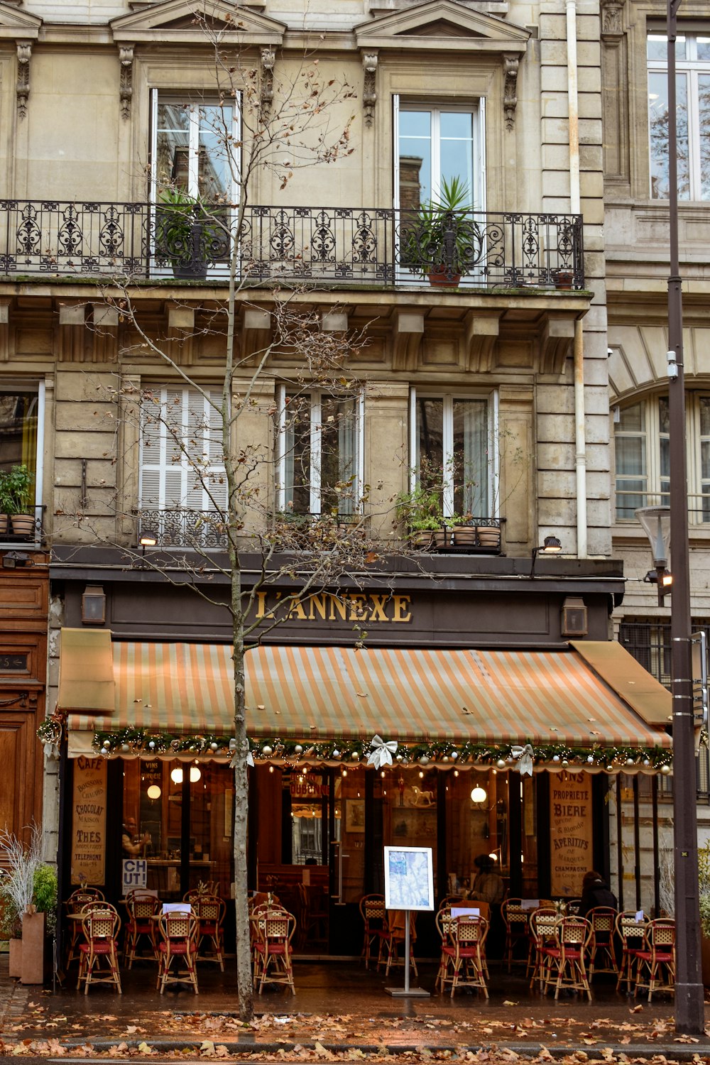 a restaurant with tables and chairs in front of a building