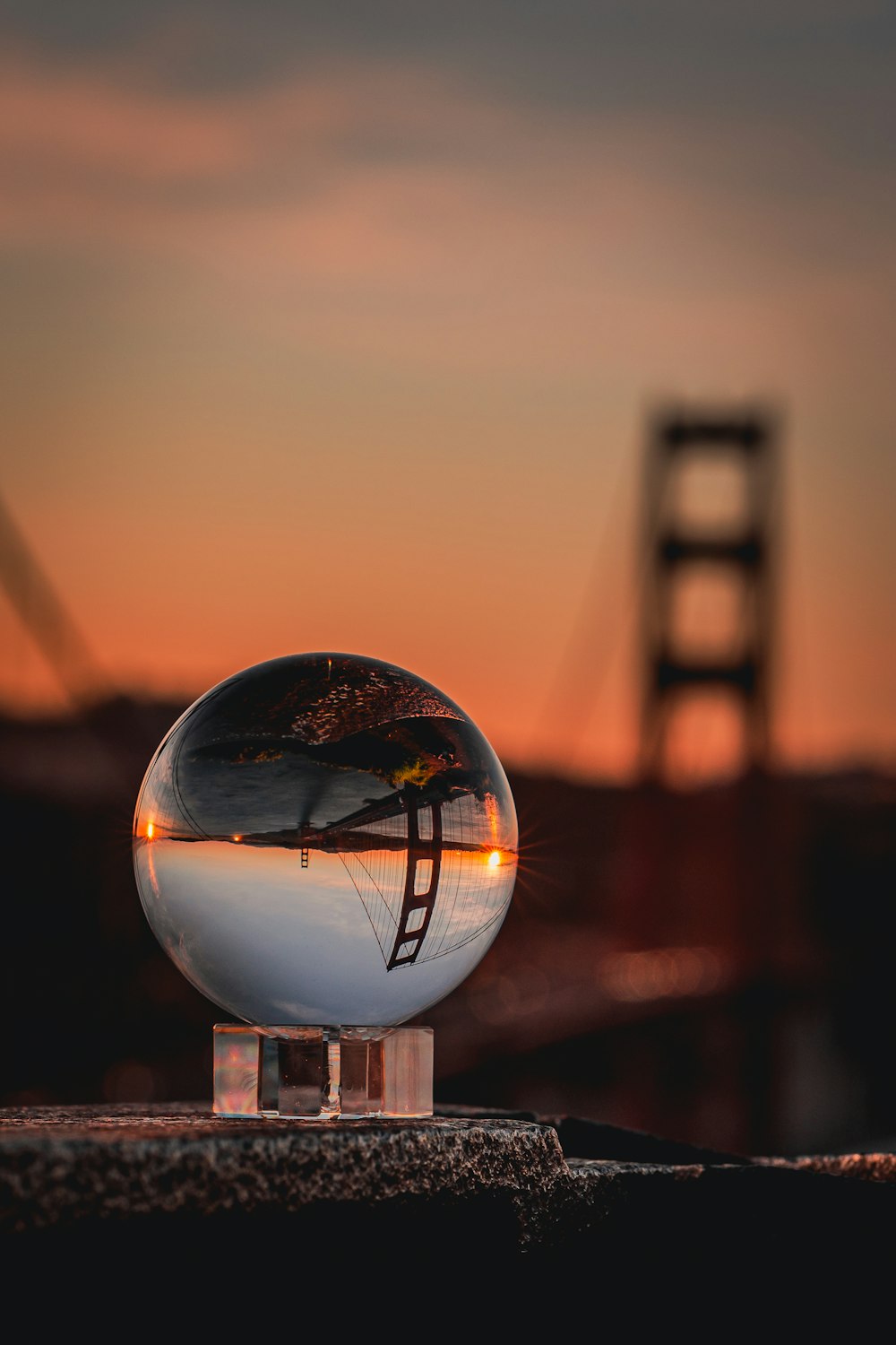 a glass ball with a bridge in the background