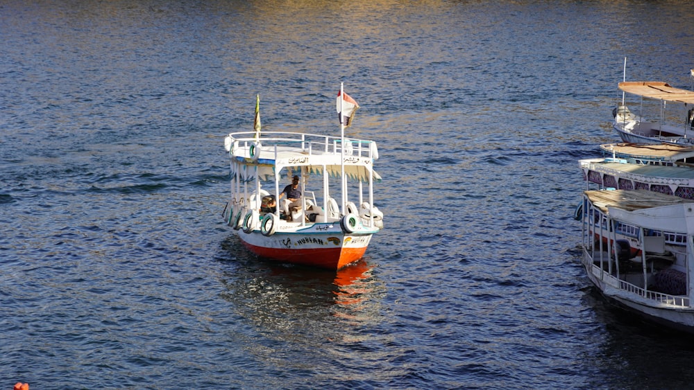 a boat floating on top of a river next to another boat