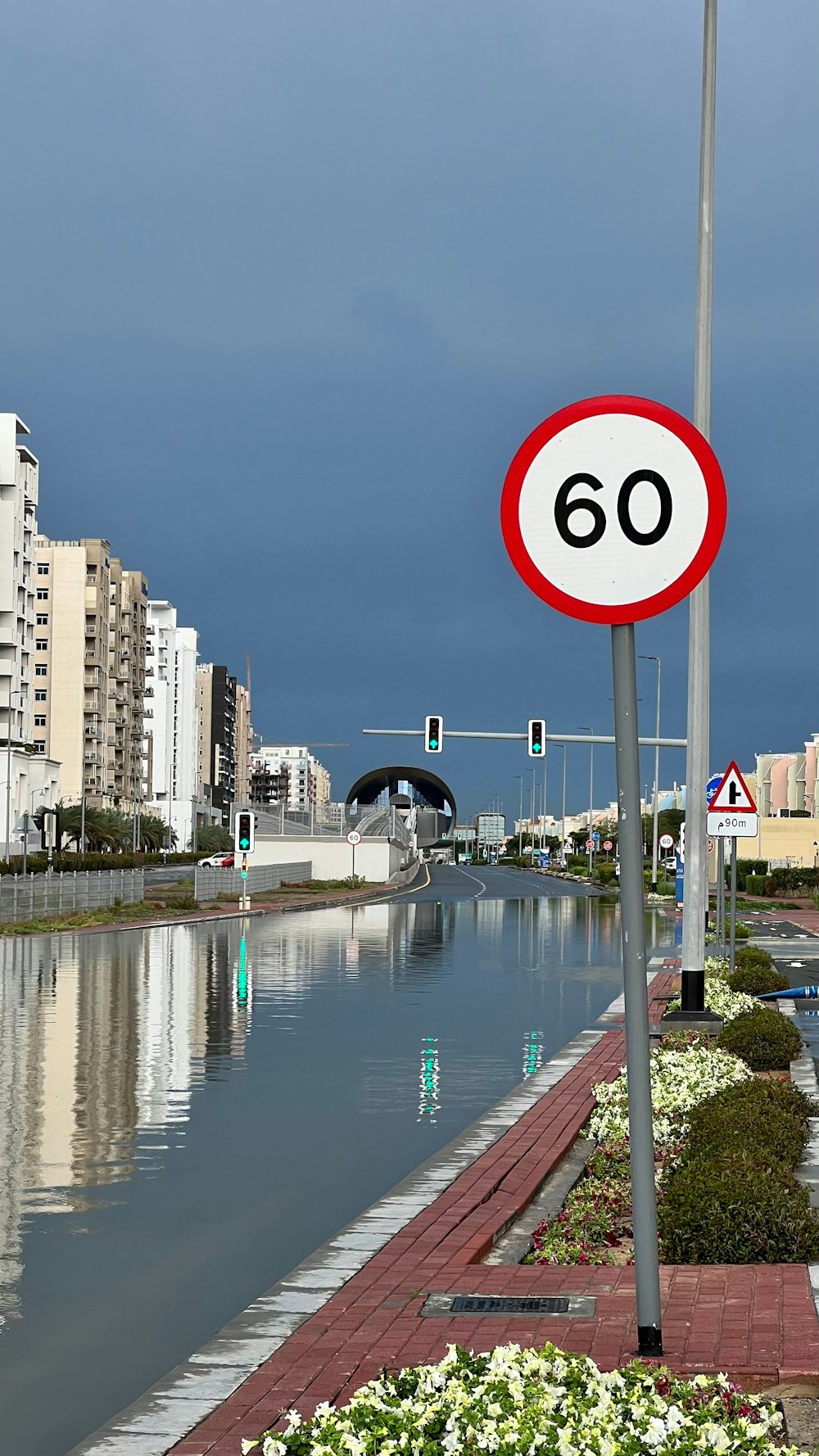 a red and white sign sitting on the side of a river