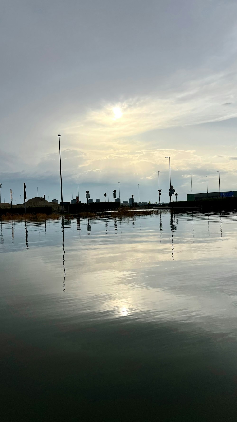 a body of water with a sky in the background