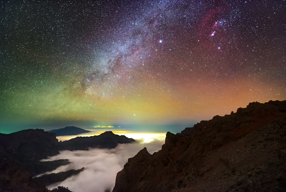 a view of the night sky from the top of a mountain