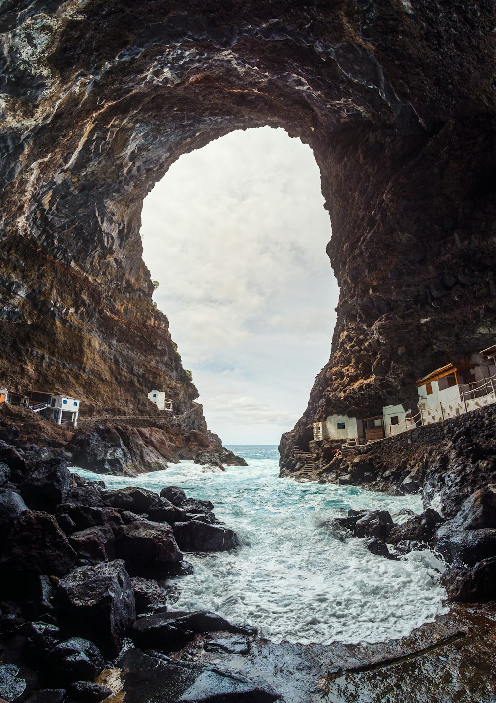 a view of a body of water from inside a cave