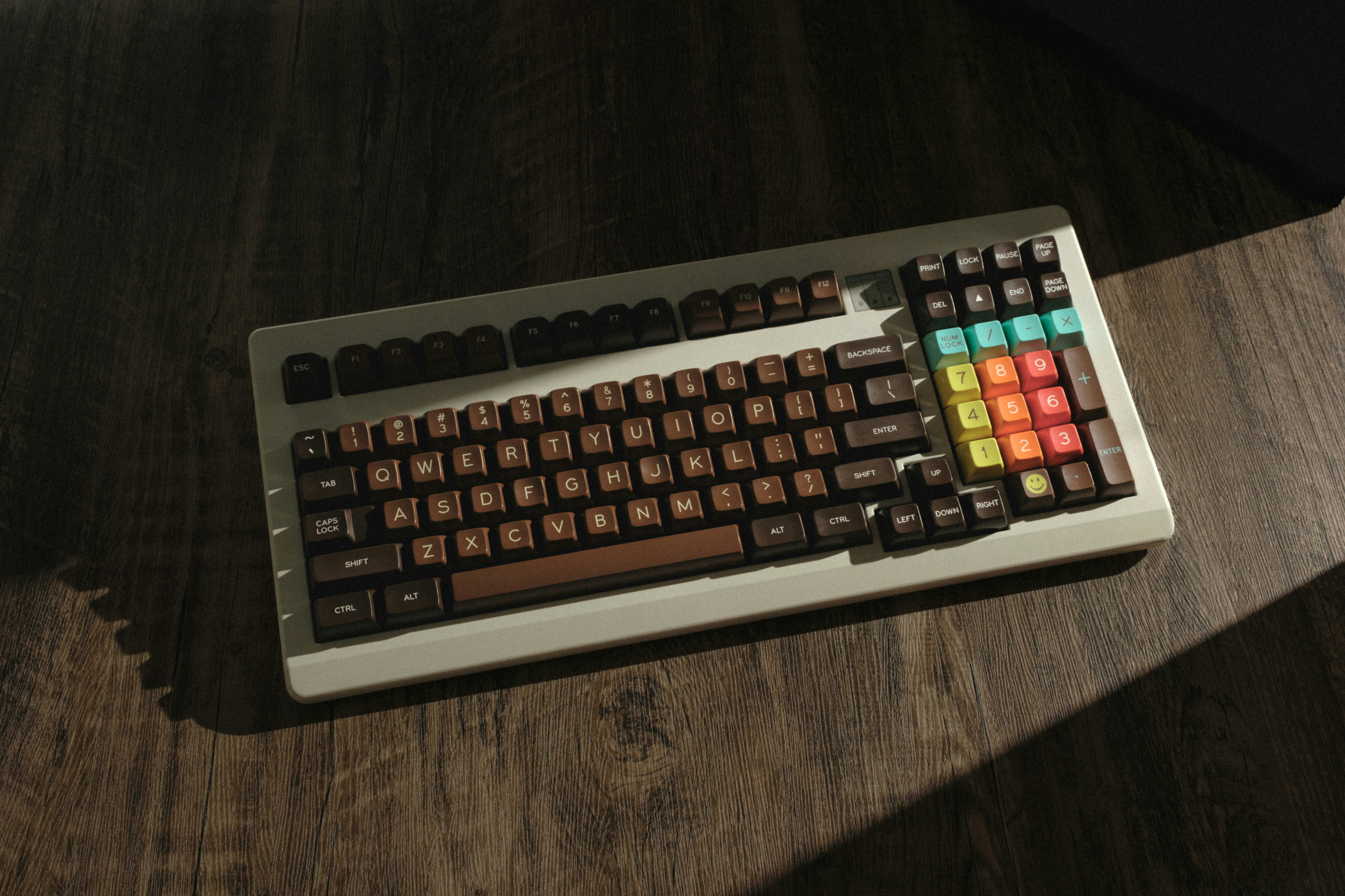 a computer keyboard sitting on top of a wooden table