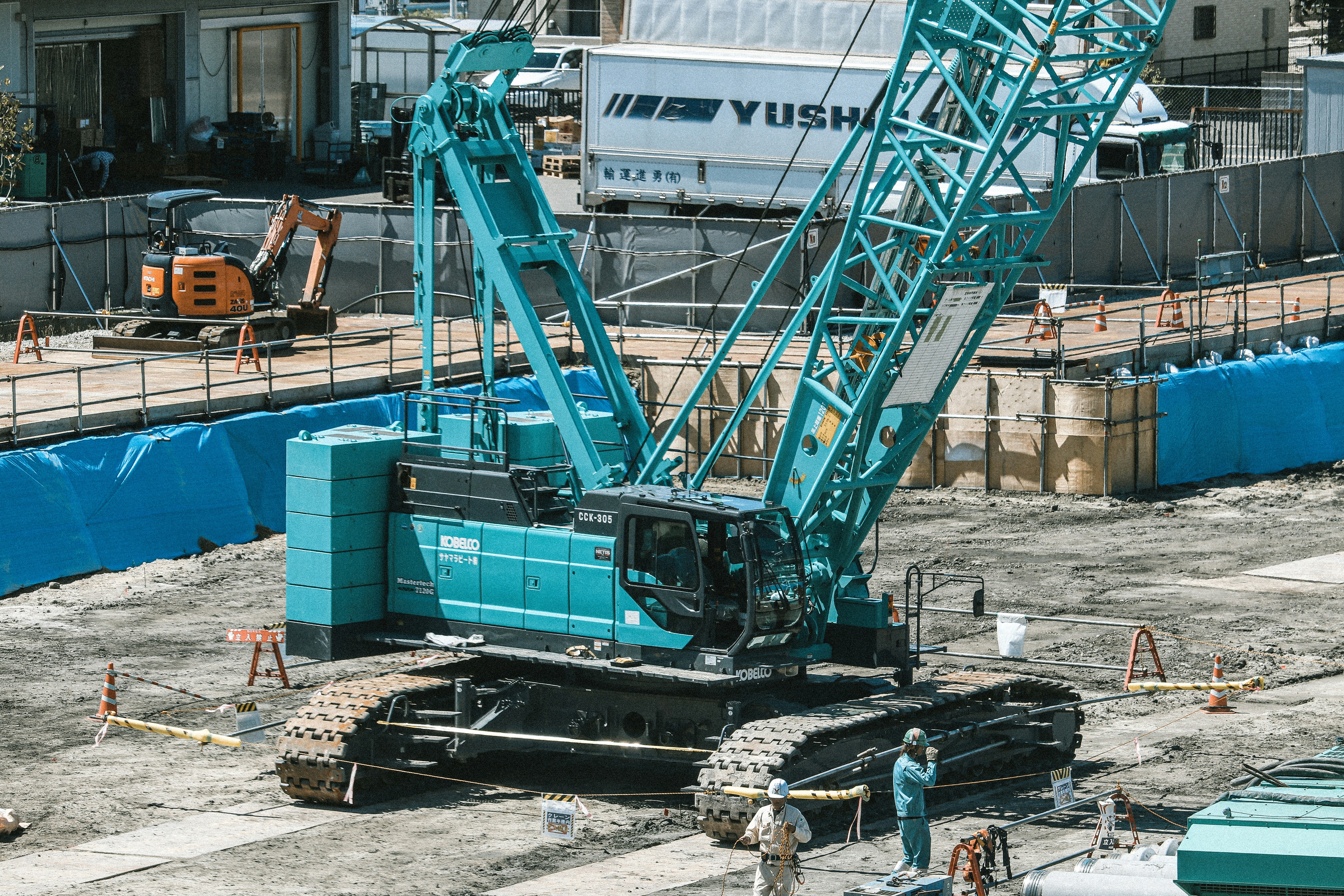 a large blue crane sitting on top of a construction site