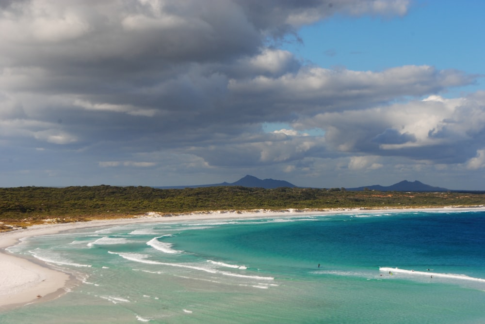 a view of a beach with people in the water