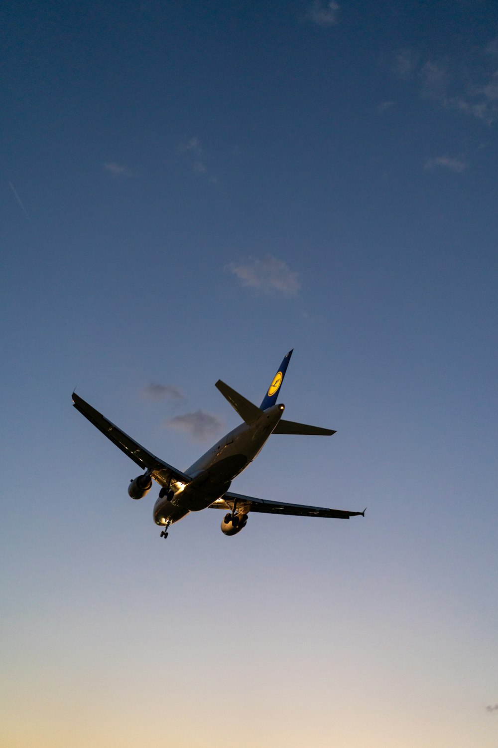 a large jetliner flying through a blue sky