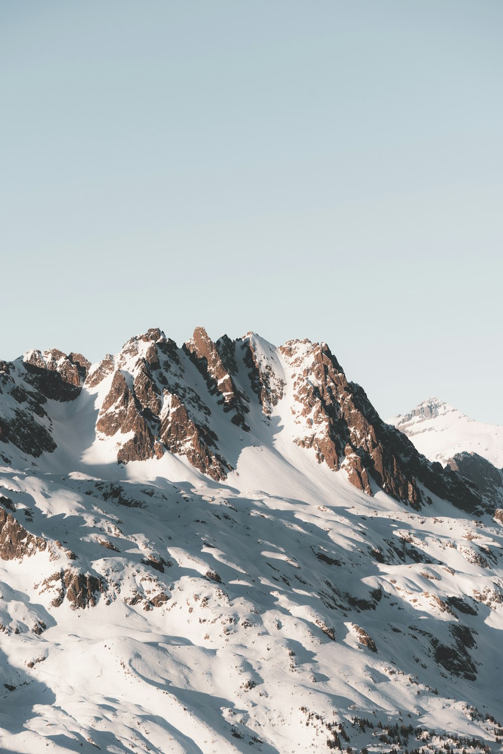 a snow covered mountain with a sky background