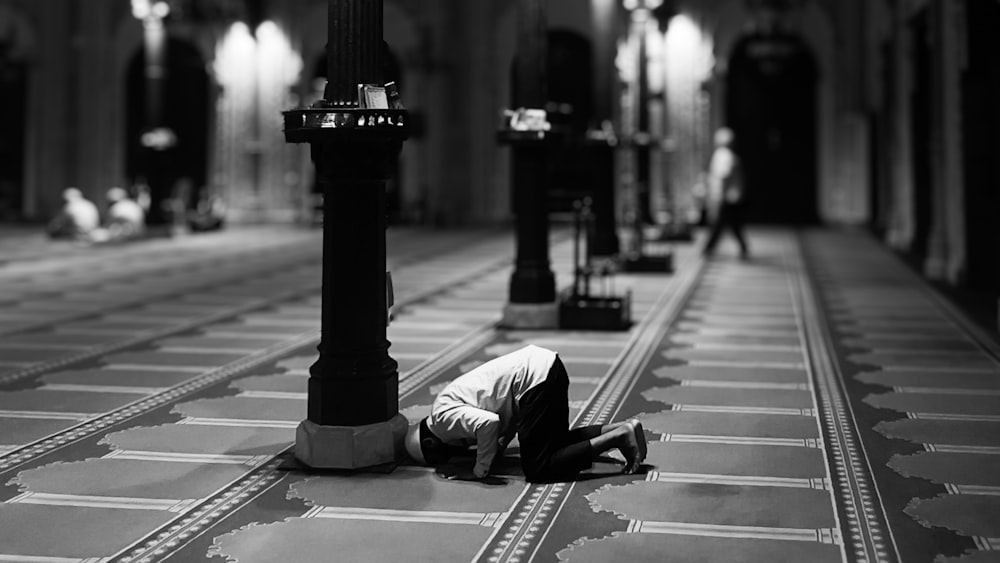 a man laying on the floor of a church