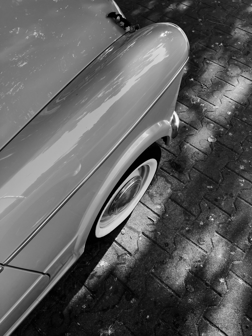 a black and white photo of a vintage car