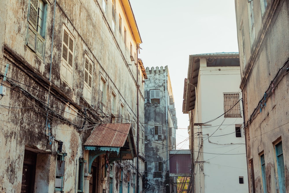 a narrow alley way with a clock tower in the background