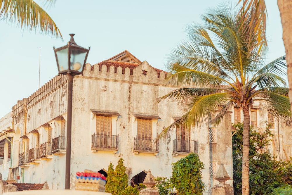 an old building with a palm tree in front of it