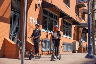 a couple of people that are on some kind of scooter