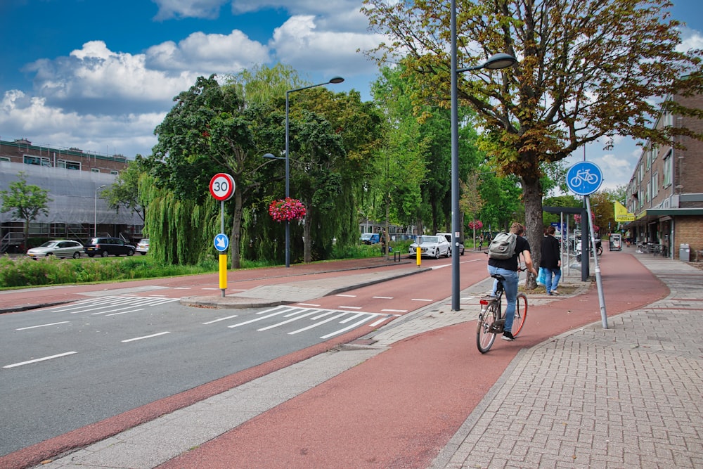 a person riding a bike on a city street