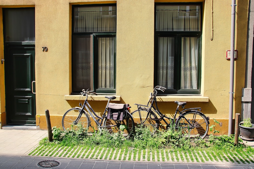 a couple of bikes are parked in front of a building