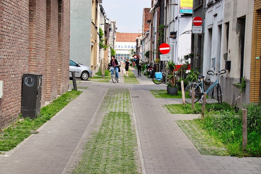 a couple of people riding bikes down a street