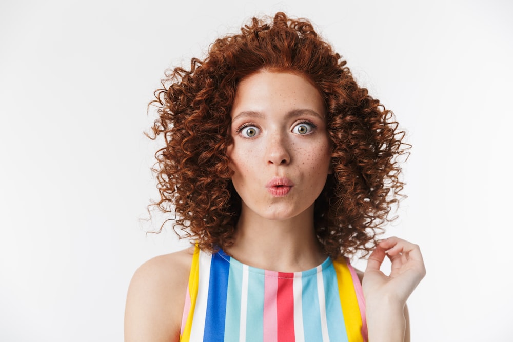 a woman with curly hair making a funny face