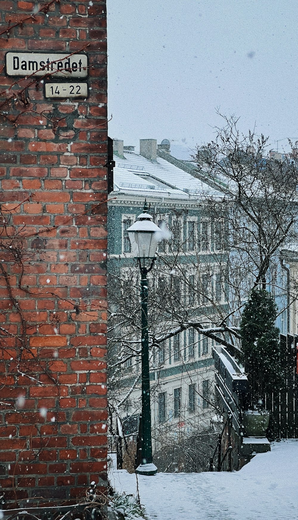 a street sign on the side of a brick building