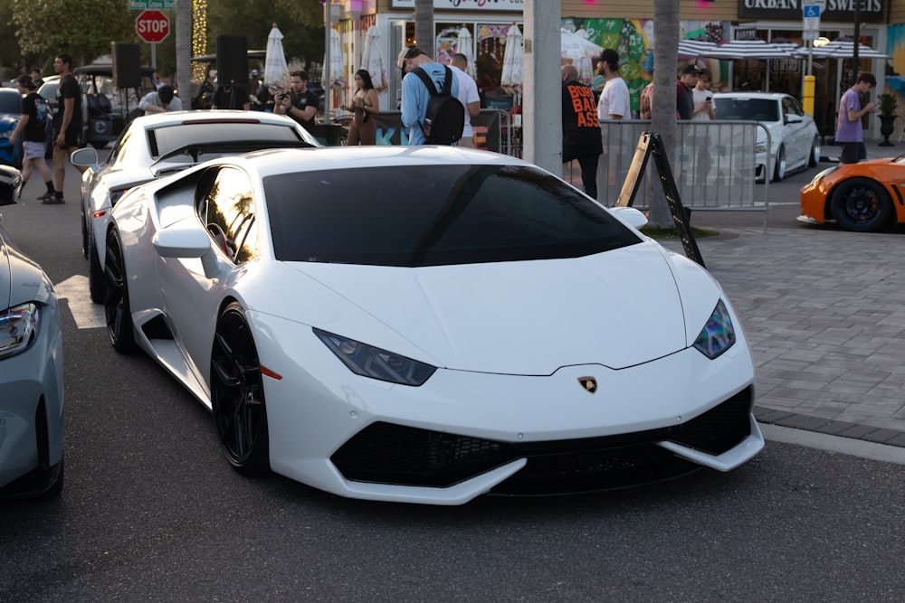 a white sports car parked on the side of the road