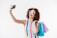 a woman wearing sunglasses and holding a cell phone