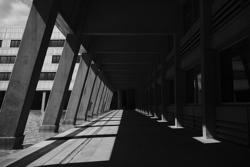 a black and white photo of a long hallway