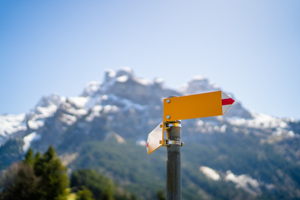 a street sign with a mountain in the background