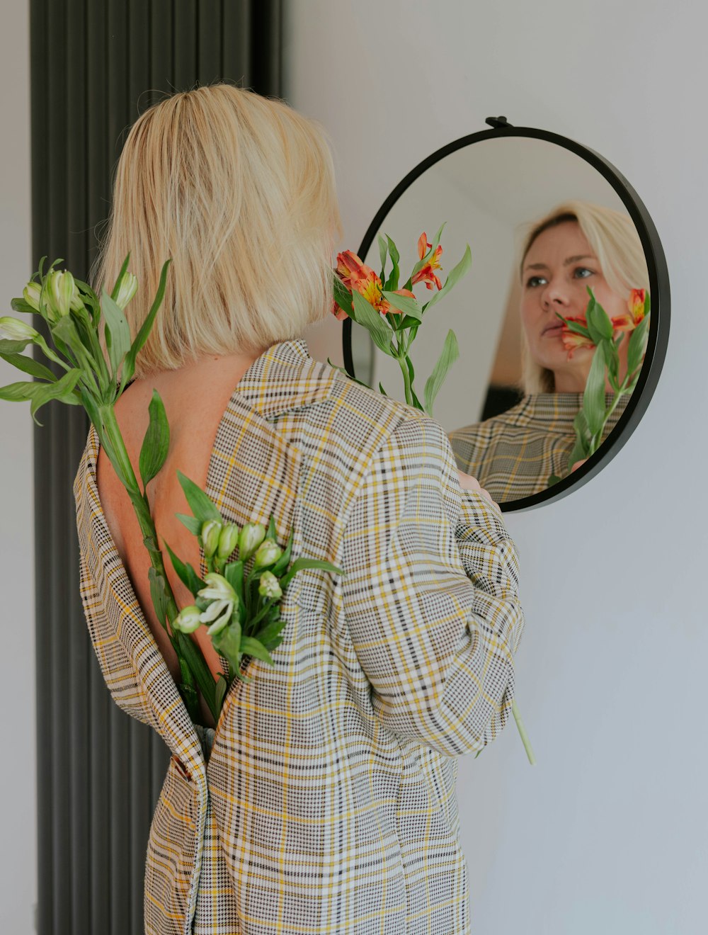 a woman looking at herself in the mirror