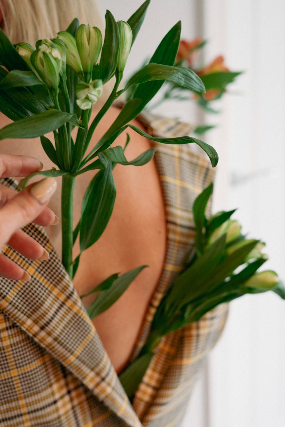 a woman is holding a flower in her hands