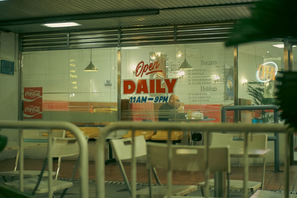 a store front with chairs and tables in front of it