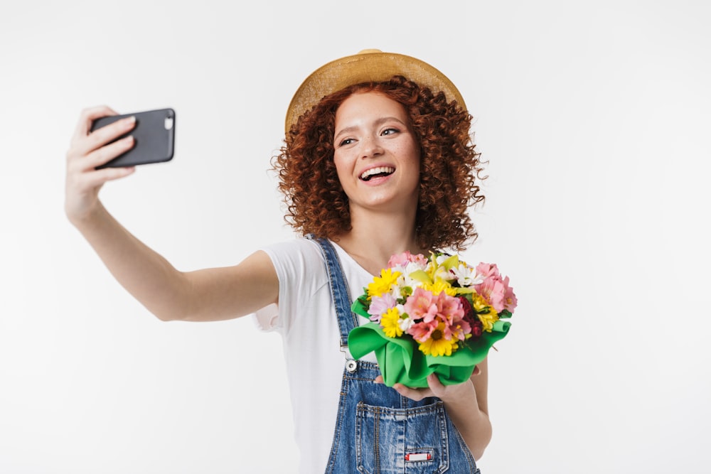 a woman taking a selfie with a flower bouquet