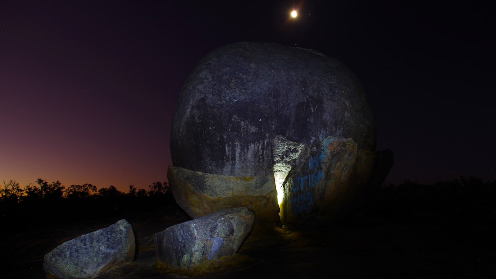 a large rock in the middle of a field