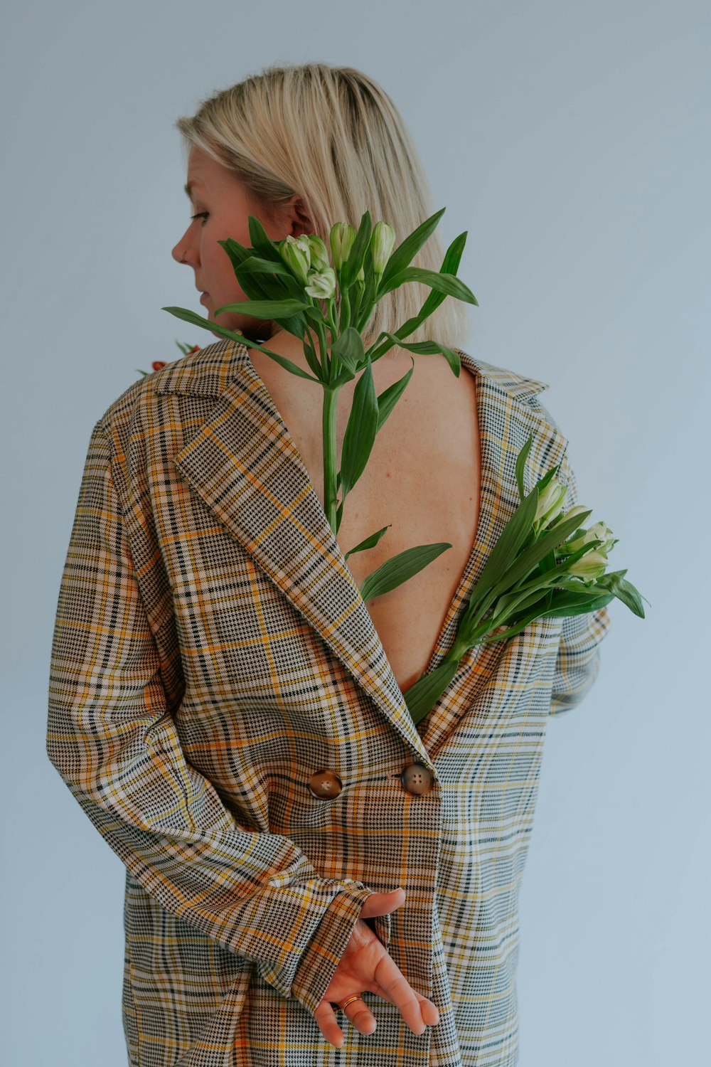 a woman wearing a jacket with flowers in her hair