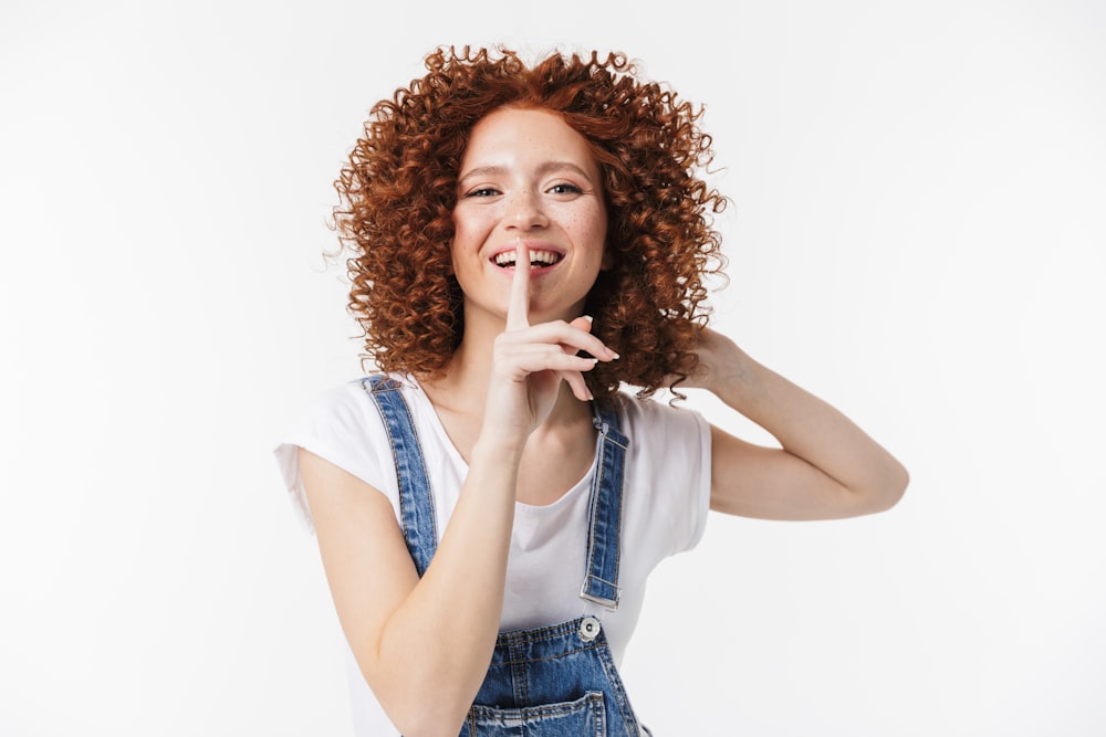 a woman with curly hair is making a funny face