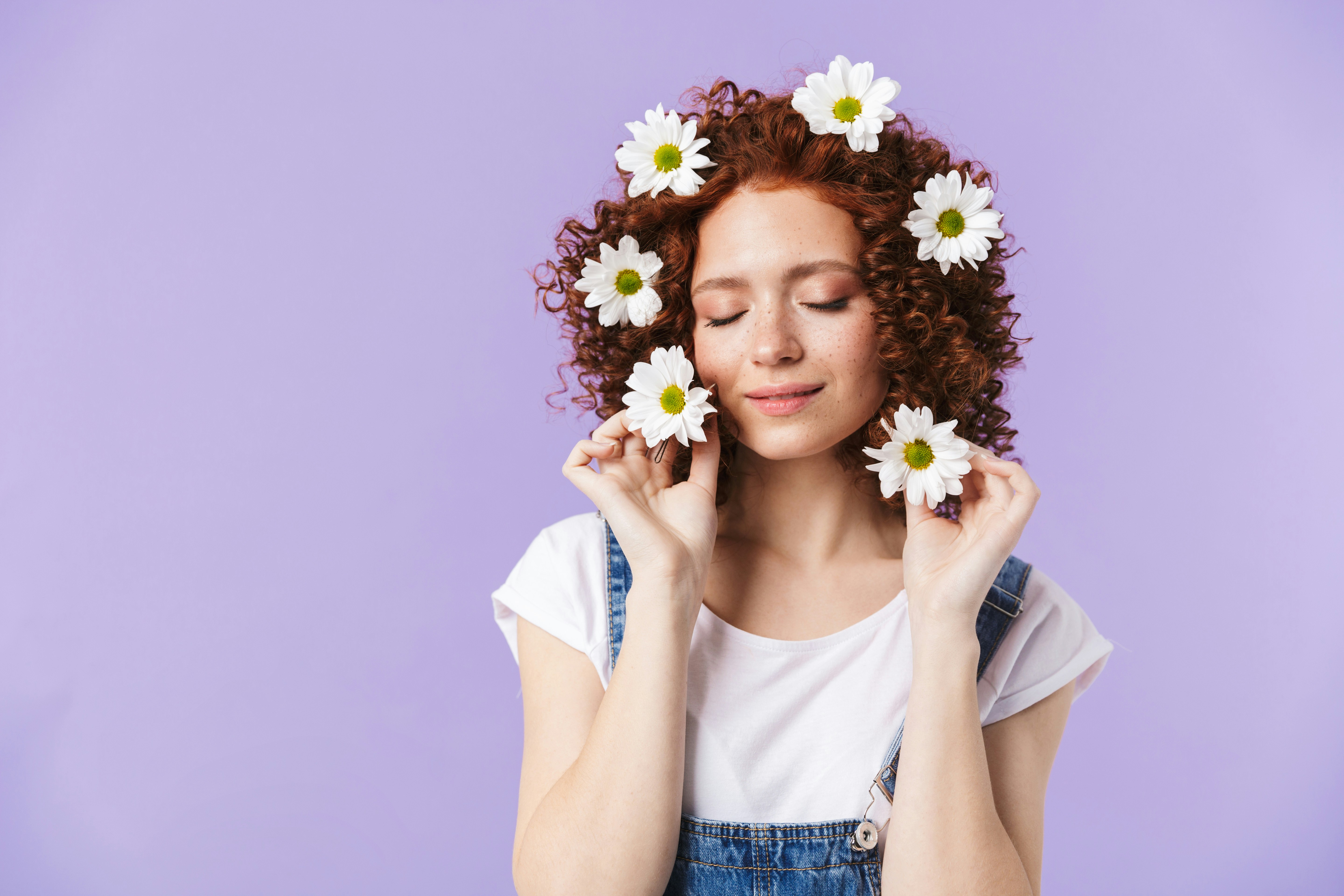 a woman with red hair and white flowers in her hair