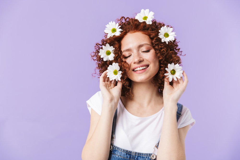 a woman with red hair and white flowers in her hair