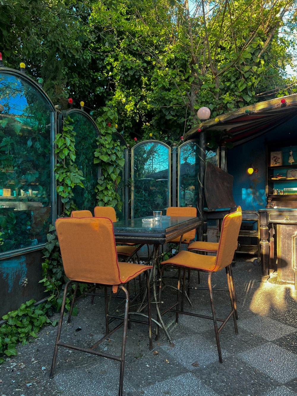 an outdoor dining area with a table and chairs