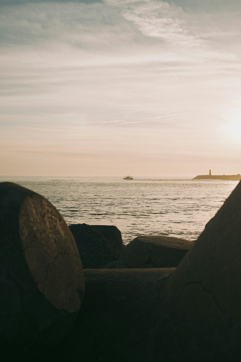 a couple of rocks sitting on top of a beach