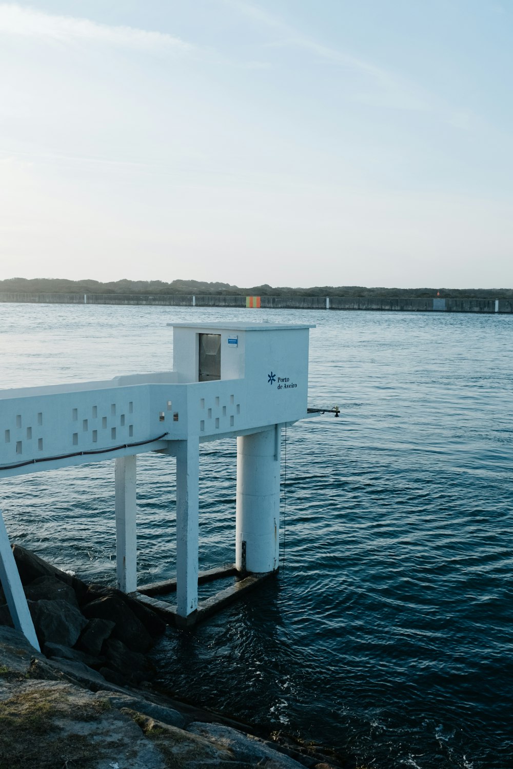 a white structure sitting on top of a body of water