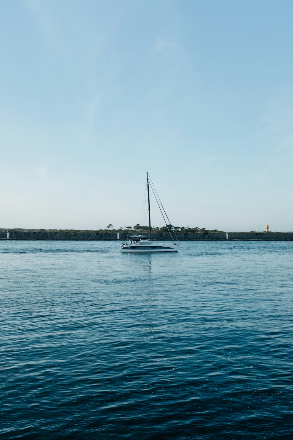 a sailboat floating on a large body of water