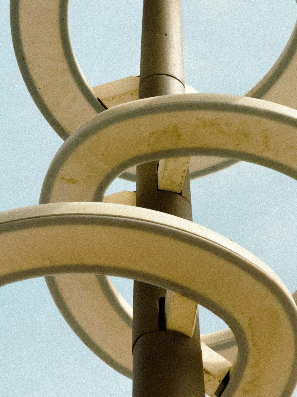 a close up of a metal object with a sky background