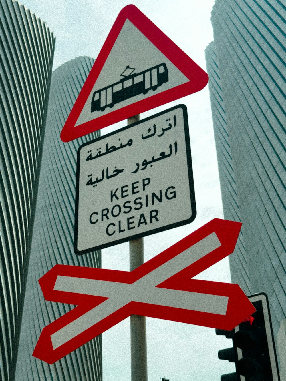 a street sign in a foreign language on a pole