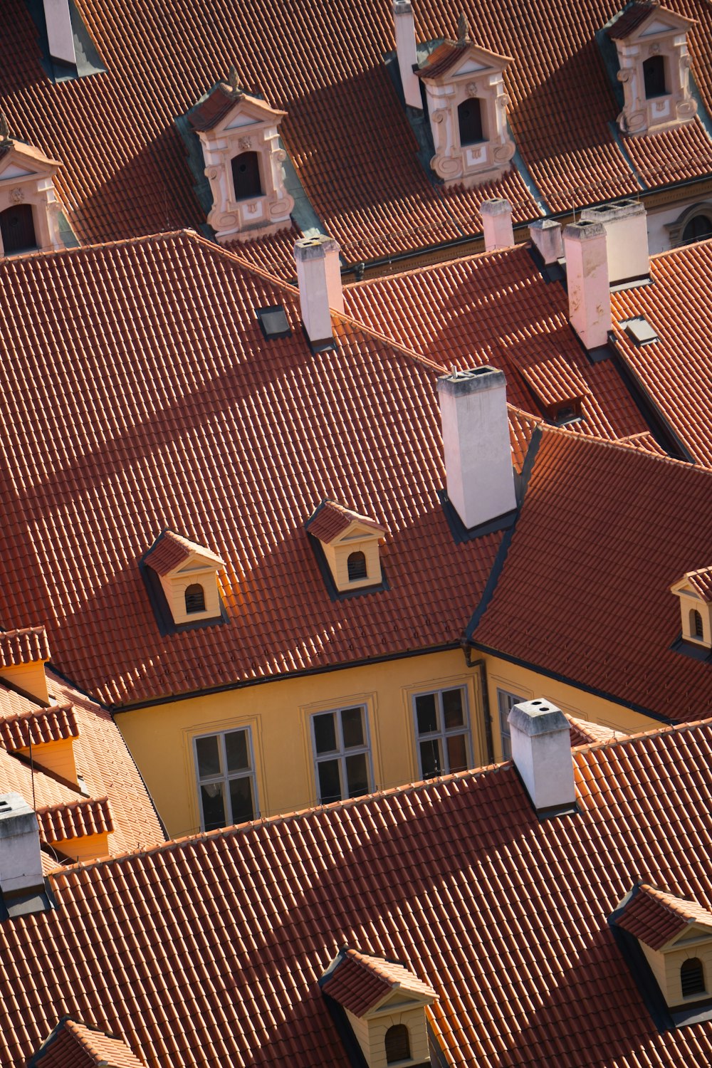 a group of rooftops with a clock on each of them