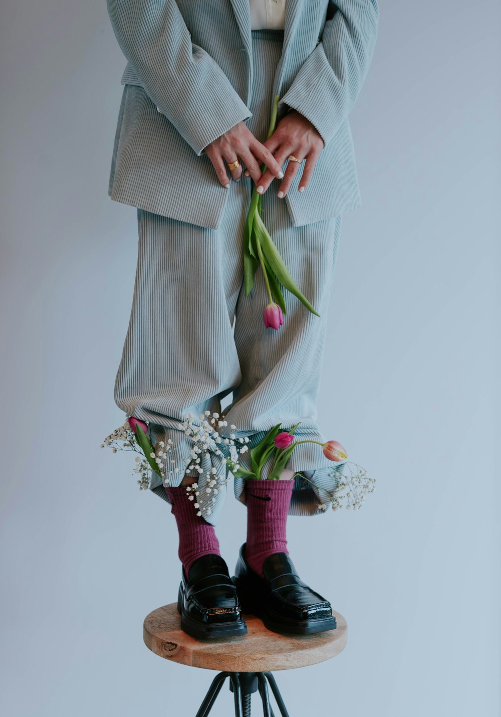 a man in a suit and tie standing on top of a stool