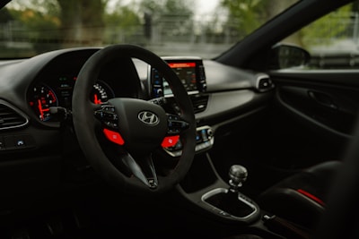 the interior of a car with a steering wheel and dashboard