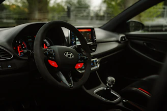 the interior of a car with a steering wheel and dashboard